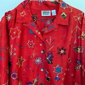 Woman’s long-sleeved silk embroidered blouse by Chico’s Design.